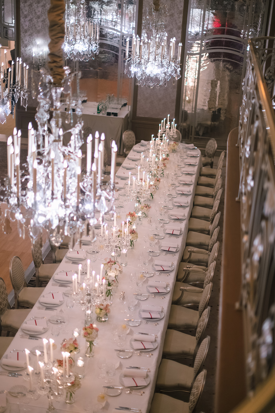 Wedding ballroom table beneath chandeliers at Hôtel Plaza Athénée Paris